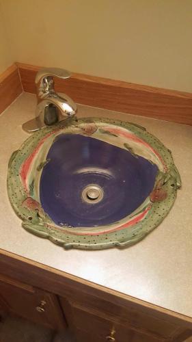 a blue sink with a faucet on a counter at Spectacular Large Group Accommodations With Gallatin River Access! in Bozeman