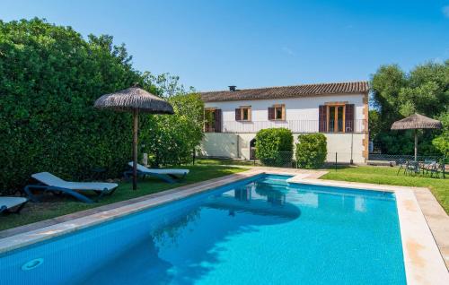 a swimming pool in front of a house at Can Polito in Can Picafort