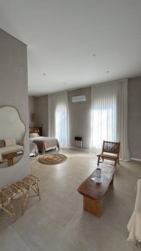 a large living room with a couch and a table at Casa Bora Hotel Boutique in San Antonio de Areco