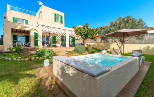 a swimming pool in front of a house at Sa Copinya in Cala Bona