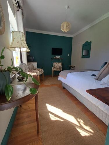 a bedroom with a bed and a table and a couch at 7th Heaven Guest Unit in Paarl