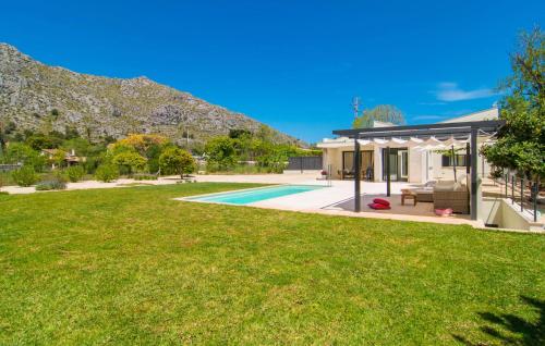 a house with a swimming pool and a yard at Ternelles in Pollença