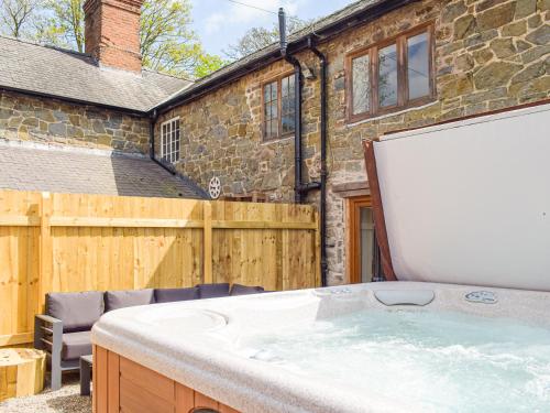 a hot tub in the backyard of a house at Wheelwright Cottage in Clunbury
