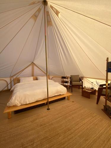 a bedroom with a bed in a tent at Sahara Dream Camp in Al Raka
