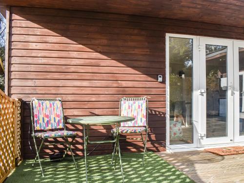 two chairs and a table on a patio at The Stables in Edmondsham