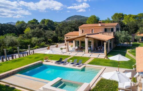 an aerial view of a house with a swimming pool at Golf Marina in Pollença