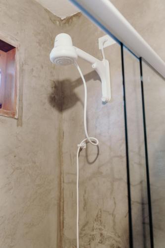 a shower with a white light in a bathroom at Pousada Brisa Del Mar in Icaraí