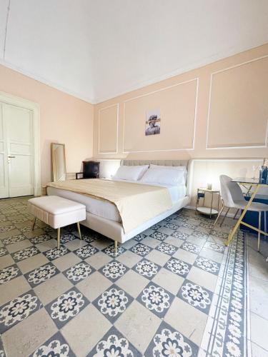 a bedroom with a large bed and a tiled floor at Flame B&B in Catania