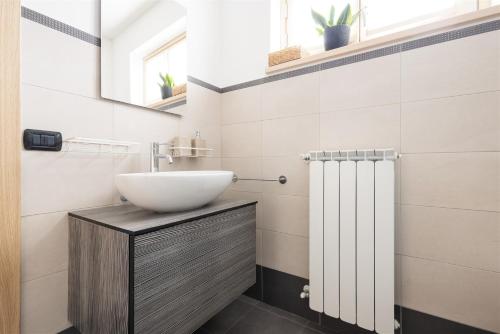 a bathroom with a sink and a shower at IseoLakeRental - Panorama House in Parzanica