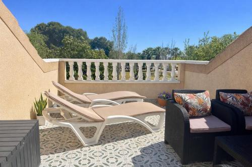 a patio with two chairs and a table at Casa Moolio - Private Holiday Home with Pool Access, Walk to Beach & Restaurants in Los Alcázares
