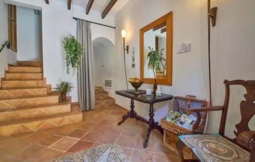 a hallway with stairs and a table and a mirror at Maria Angela in Artá