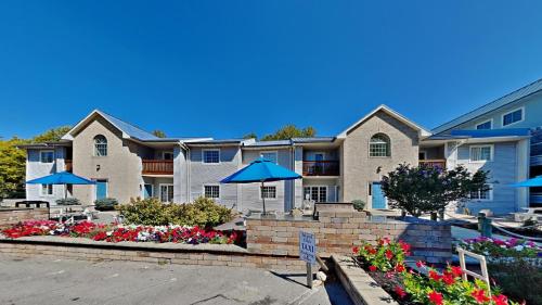 a large apartment building with umbrellas in a parking lot at Put-in-Bay Poolview Condo #6 in Put-in-Bay