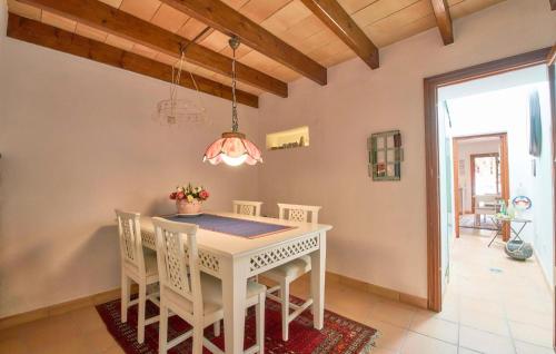 a dining room with a white table and chairs at Maria Angela in Artá