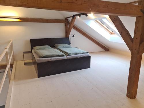 a bedroom with a bed in a attic at Loft zum alten Kraftwerk in Herzogenburg