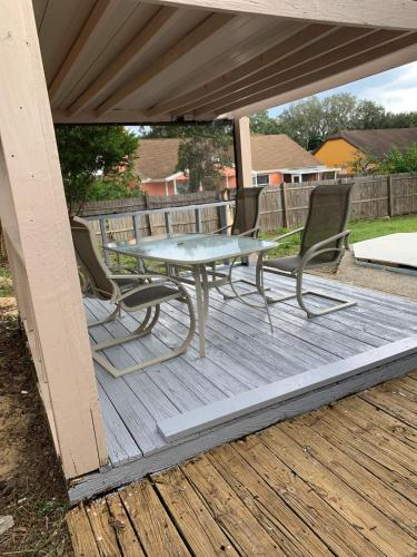 a table and chairs on a wooden deck at Ortona's Best Kept Secret Three-Two Spacious Home in Orlando