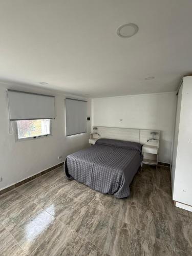 a bedroom with a bed in a white room at Casa Rincon caleta in Mar de Cobo
