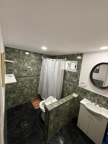 a bathroom with a toilet and a sink and a mirror at Casa Rincon caleta in Mar de Cobo