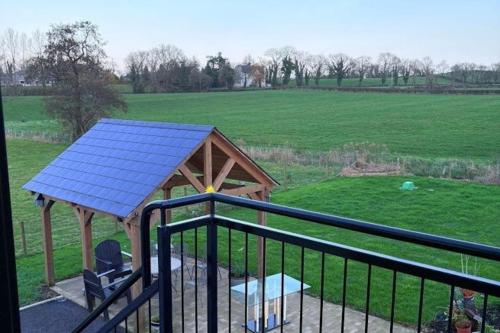 a gazebo with a blue roof next to a field at Lisburn - 1 Bedroom - sleeps 2 - Street parking in Lisburn