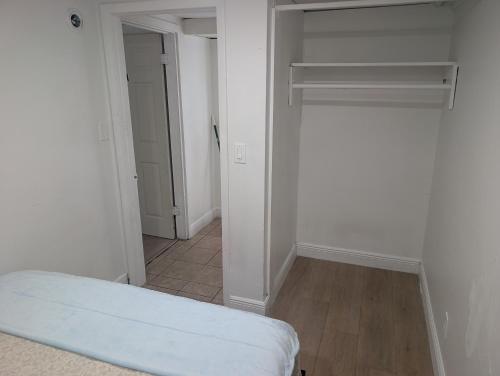 an empty room with a bed and a closet at St Pete Studio Rooms in St. Petersburg