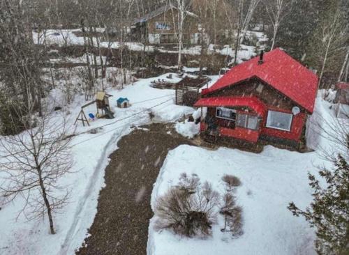 a house with a red roof in the snow at Spa - Waterfront - La Source in Saint Come