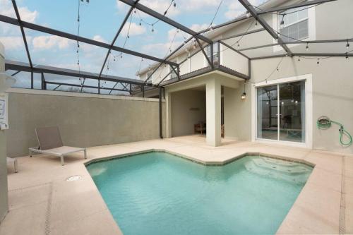 a swimming pool in the middle of a house at Storey Lake 4BR w/ Private Pool near Disney in Kissimmee