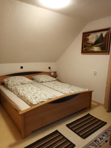 a bedroom with a large bed in a room at Erholsame Westerwälder Ferienwohnung in Weitefeld