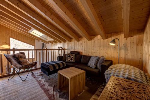 a living room with a couch and a table at Chalet Renard Roux in La Tzoumaz