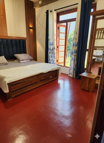 a bedroom with a bed and a large window at HA Homes in Matale