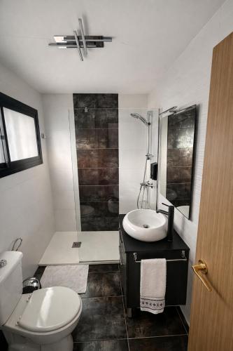a bathroom with a toilet and a sink and a shower at Apartamento Luxury in Maspalomas