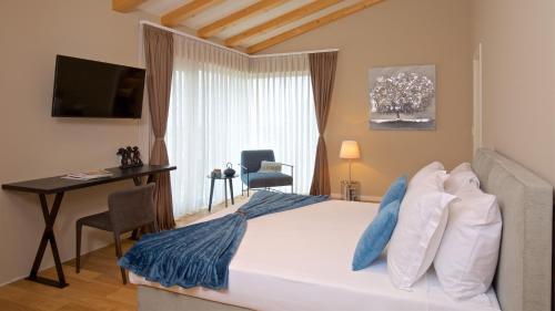 a bedroom with a bed with a desk and a window at Deluxe Villa with heated pool in Brtonigla