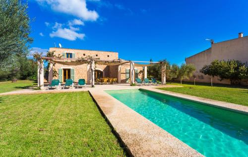 a villa with a swimming pool in front of a house at Ses Fonolleres in Son Servera