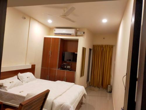 a bedroom with a bed and a television in it at Casal stay in Mannārakkāt