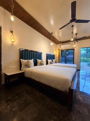 a bedroom with a large white bed with a ceiling at Royal cottage by royale palace in Mount Ābu