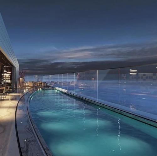 a large swimming pool on top of a building at 2401 at Mercury by AURA in St. Julianʼs