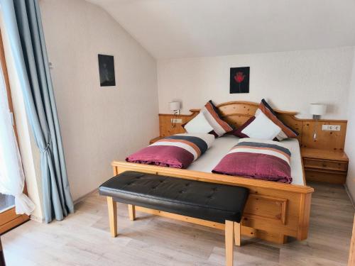 a bedroom with a large wooden bed with pillows at Ferienwohnung Soiernblick Krün Bärnbichl in Krün