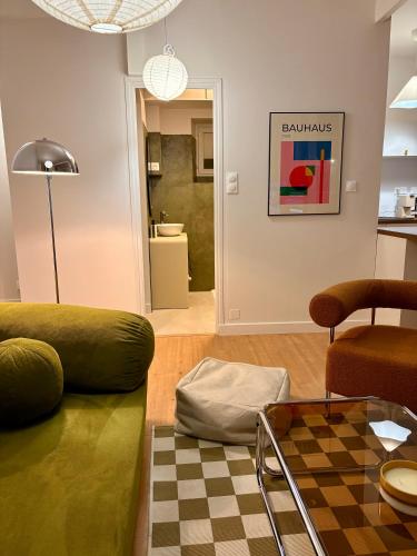 a living room with a couch and a table at Charmant T2 hyper-centre, proche gare & mer in Saint-Brieuc
