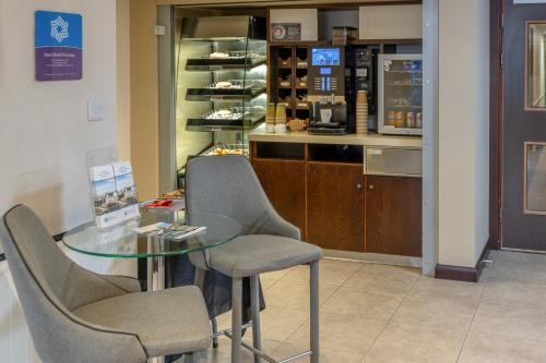 a glass table and chairs in a store at Fortune Hotel, Huddersfield West Yorkshire, Sure Collection by Best Western in Huddersfield
