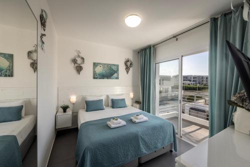 a bedroom with a bed and a large window at Protaras Villa Alina in Protaras