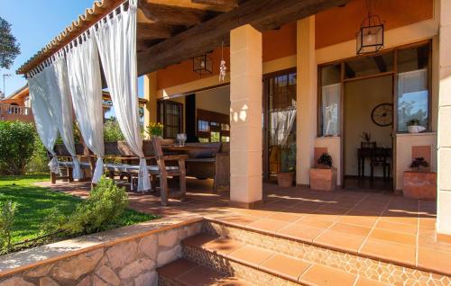 a house with a patio with a table and chairs at Estrella De Son Serra in Son Serra de Marina