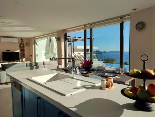 a kitchen with a counter with a view of the ocean at Villa Ship Ahoy in Kaş
