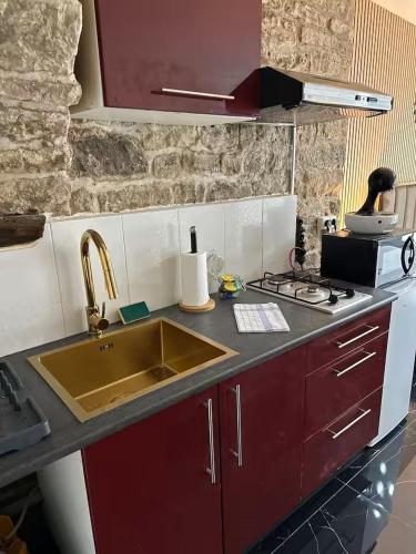 a kitchen with a sink and a counter top at Jacuzzi des Voutes in Vesoul