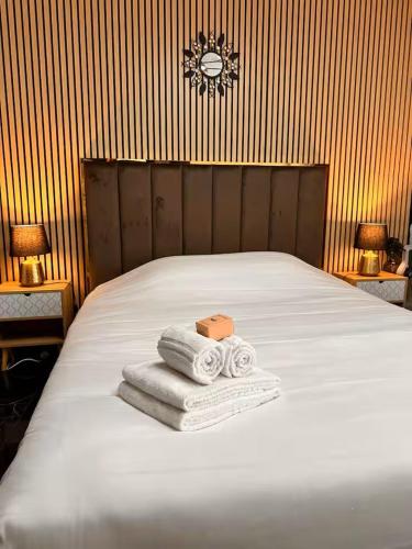 a bedroom with a bed with towels on it at Jacuzzi des Voutes in Vesoul