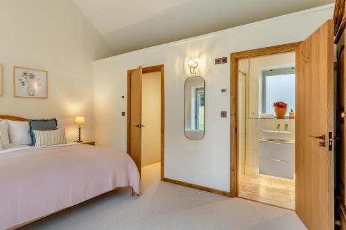 a bedroom with a bed and an open door at 2 Bed in Melplash oc-r30043 in Netherbury