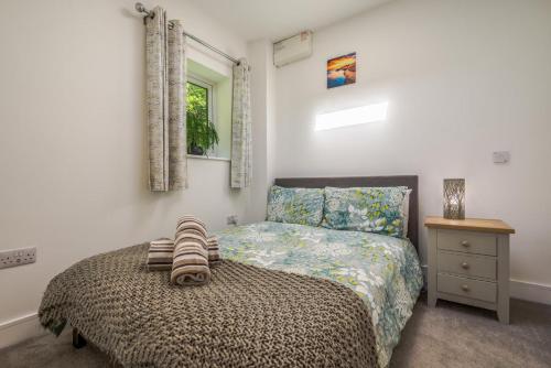 a small bedroom with a bed and a night stand at 2 Bed in Bush oc-h31844 in Bude