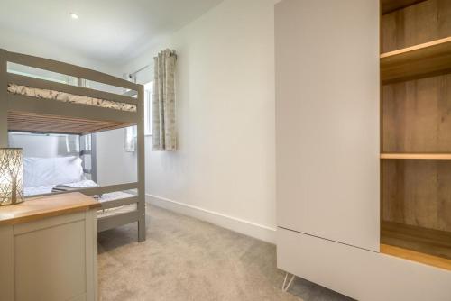 a bedroom with a bunk bed and a desk at 2 Bed in Bush oc-h31844 in Bude