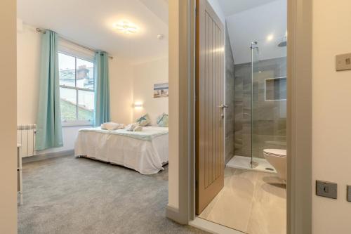 a bedroom with a bed and a bathroom with a shower at 2 Bed in St. Ives oc-s28155 in St Ives