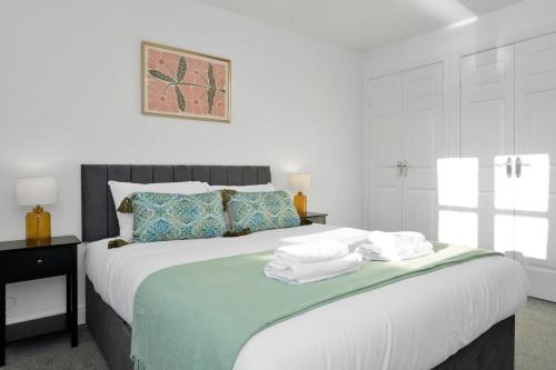 a bedroom with a large bed with towels on it at Buie's Runway Retreat in EDI