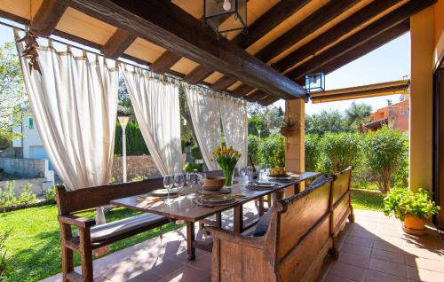 an outdoor dining room with a table and chairs at Estrella De Son Serra in Son Serra de Marina