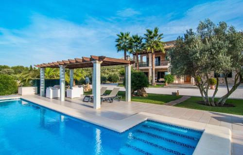 a swimming pool with a pergola next to a house at Ca Na Siona in Alcudia