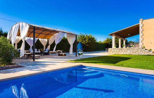 a swimming pool in a yard with a pavilion at Finca Llum in Manacor